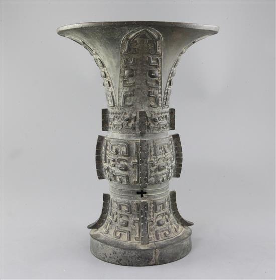 A Chinese archaic bronze ritual wine vessel, Zun, late Shang/early Western Zhou dynasty, 35.5cm high, split to foot
